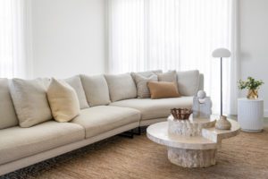 Modern lounge room with a Globewest Sofa and round Collective Haus coffee table.