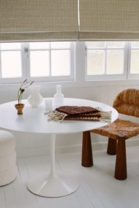 A round meeting table in an office with a Rachel Donath chair.