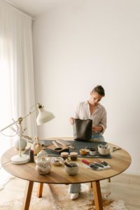 A photo of a leather artisan in her studio.