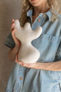 Close up of ceramic artist Tess Miller holding an organic sculpture she's made.