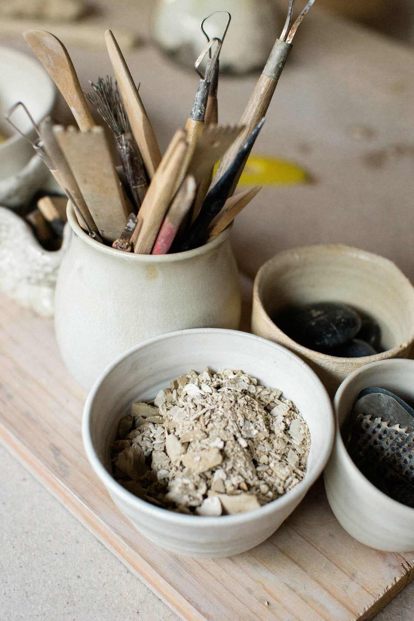 Pottery tools sitting on a desk in handmade ceramics.