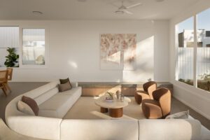 A light filled modern living room featuring a sunken lounge and abstract art.